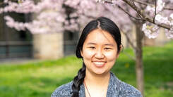 Headshot of Christine in front of pink flowers